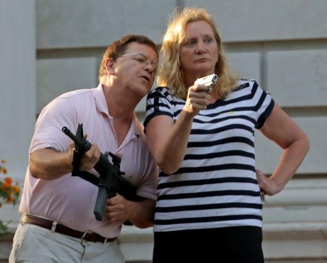 CWE couple display guns during protest